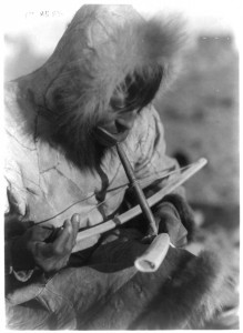Man using a bow drill. King Island, circa 1920. Photo by Edward S. Curtis, courtesy of the Library of Congress, 3a16199