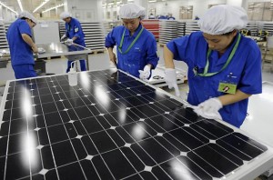 Photo courtesy of econews.com. Chinese workers manufacturing solar panels. 